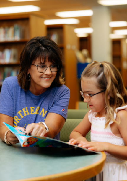teacher and girl at the library